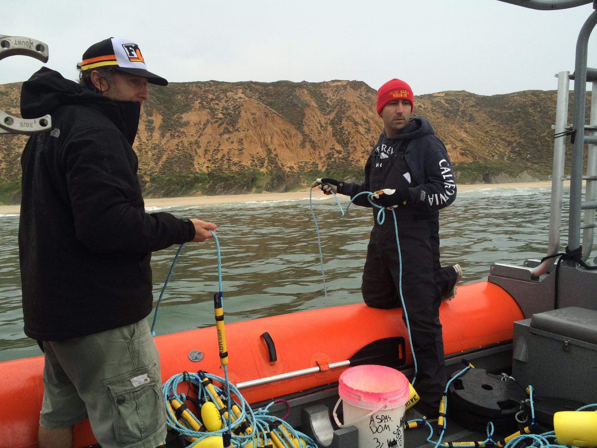 OCEANOGRAPHER JAMIE MACMAHAN AND PH.D STUDENT TUCKER FREISMUTH DEPLOY A LINE OF TEMPERATURE SENSORS IN THE NEARSHORE OFF THE COAST OF POINT SAL STATE PARK