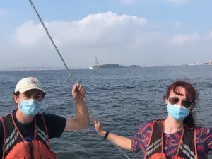 Picture in front of Statue of Liberty with William Pardis and Shawnee Traylor.