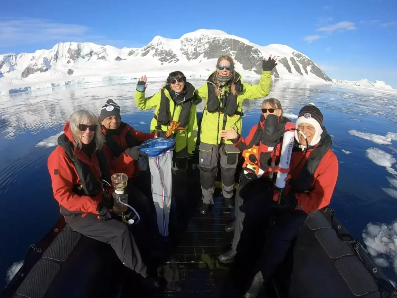 Researchers and citizen scientists on a zodiac in the Antarctic